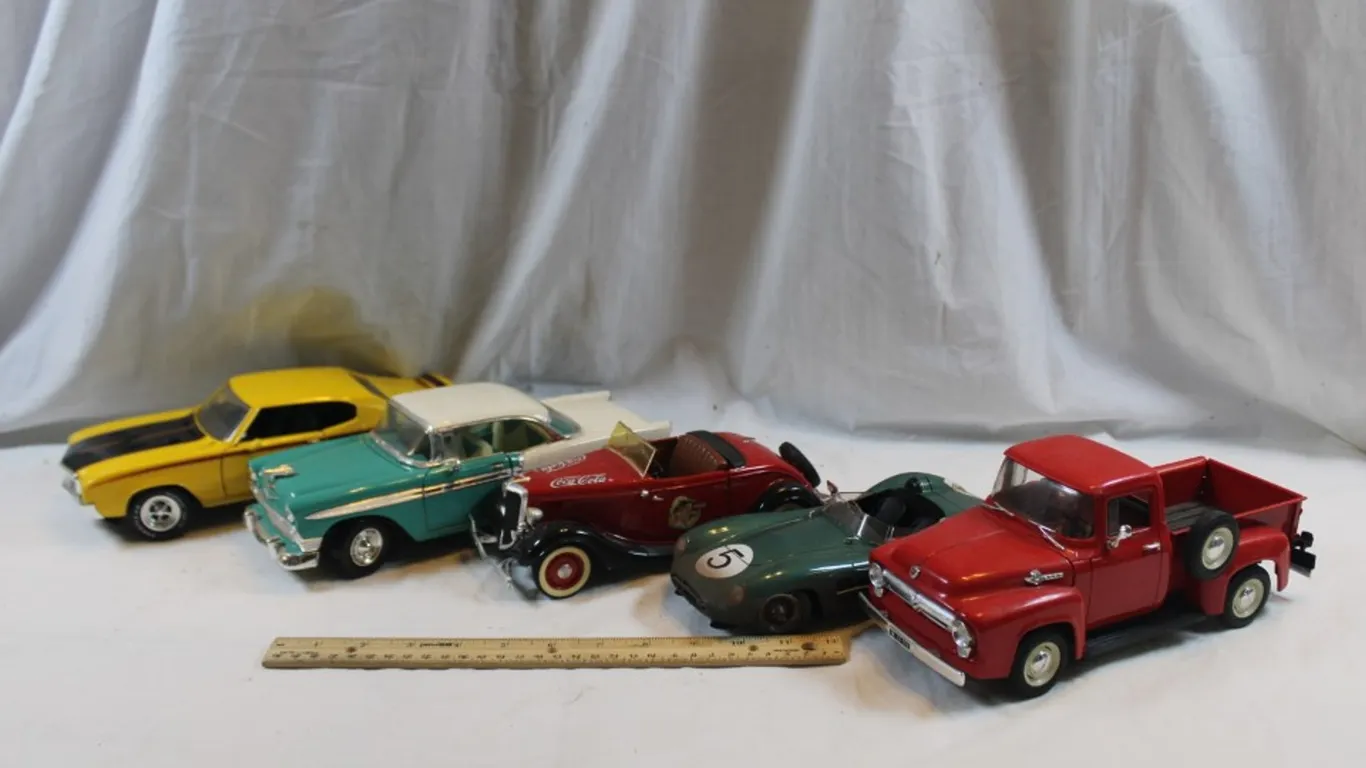 Five 1:18 Scale Diecast Models: 1970 Buick, 1956 Chevy Bel Air, Ford V8 Coca-Cola Edition, 1956 Ford F-150, and Aston Martin