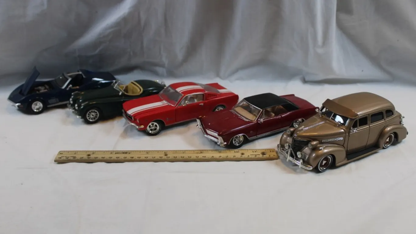 Four 1:24 Scale Diecast Model Cars