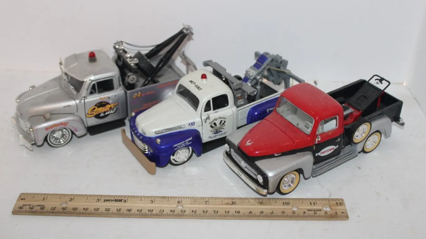 Three Die Cast Tow Trucks: 1963 Chevy, 1948 Ford, and 1954 International Coin Bank