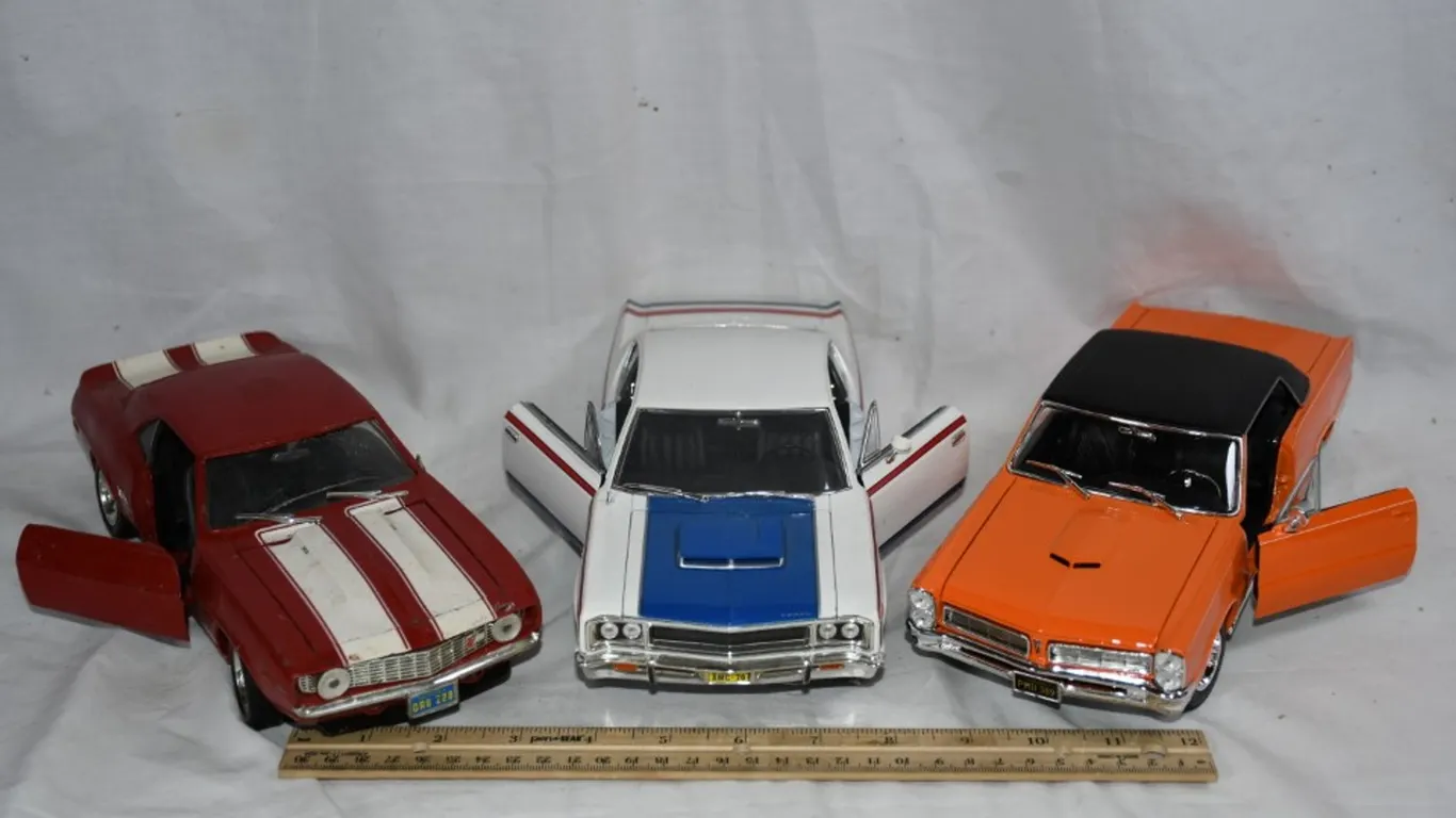 3 1:18 Scale Diecast Models: 65 GTO, 1970 AMC Rebel, and Chevy Z28 Camaro