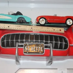 1957 Corvette Display Shelf with Two 1:18 Scale Diecast Including 1957 Corvette with a Loose Windshield and Two Loose Wheels, and a 1954 Corvette by M