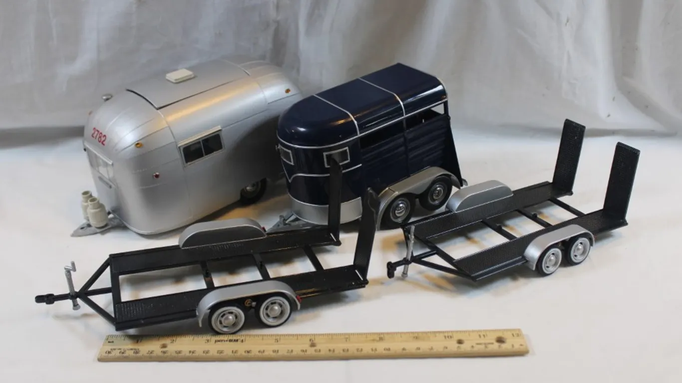 Four Diecast Trailers, One 1:18 Scale Airstream Motor City Classics, One 1:18 Scale Horse Trailer Motor City Classics, and Two Car Haulers