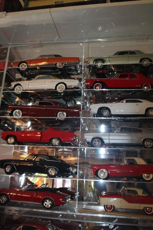 Plexiglass Display Case with Twelve 1:18 Scale Diecast Cars, Display Measures 24 x 24 x 6, Maisto 1967 Chevy Camaro RS/SS, 1959 AMC Metropolitan 1500,