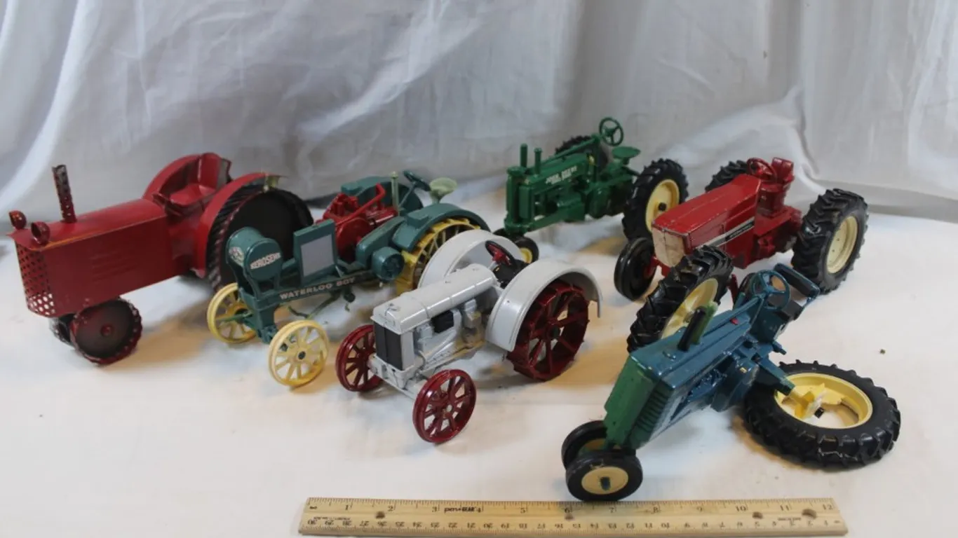 Five Diecast Tractors and a Tin Tractor. One Has a Broken Wheel
