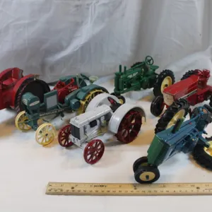 Five Diecast Tractors and a Tin Tractor. One Has a Broken Wheel