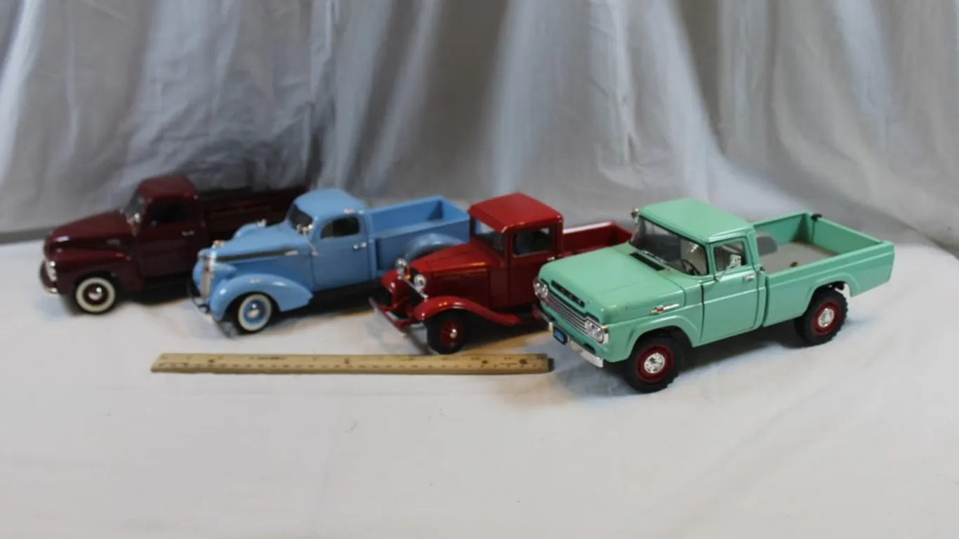 Four Diecast 1:18 Scale Models: 1950 GMC Pickup, 1937 Studebaker Pickup, 1934 Ford Pickup, and 1959 Ford F-250