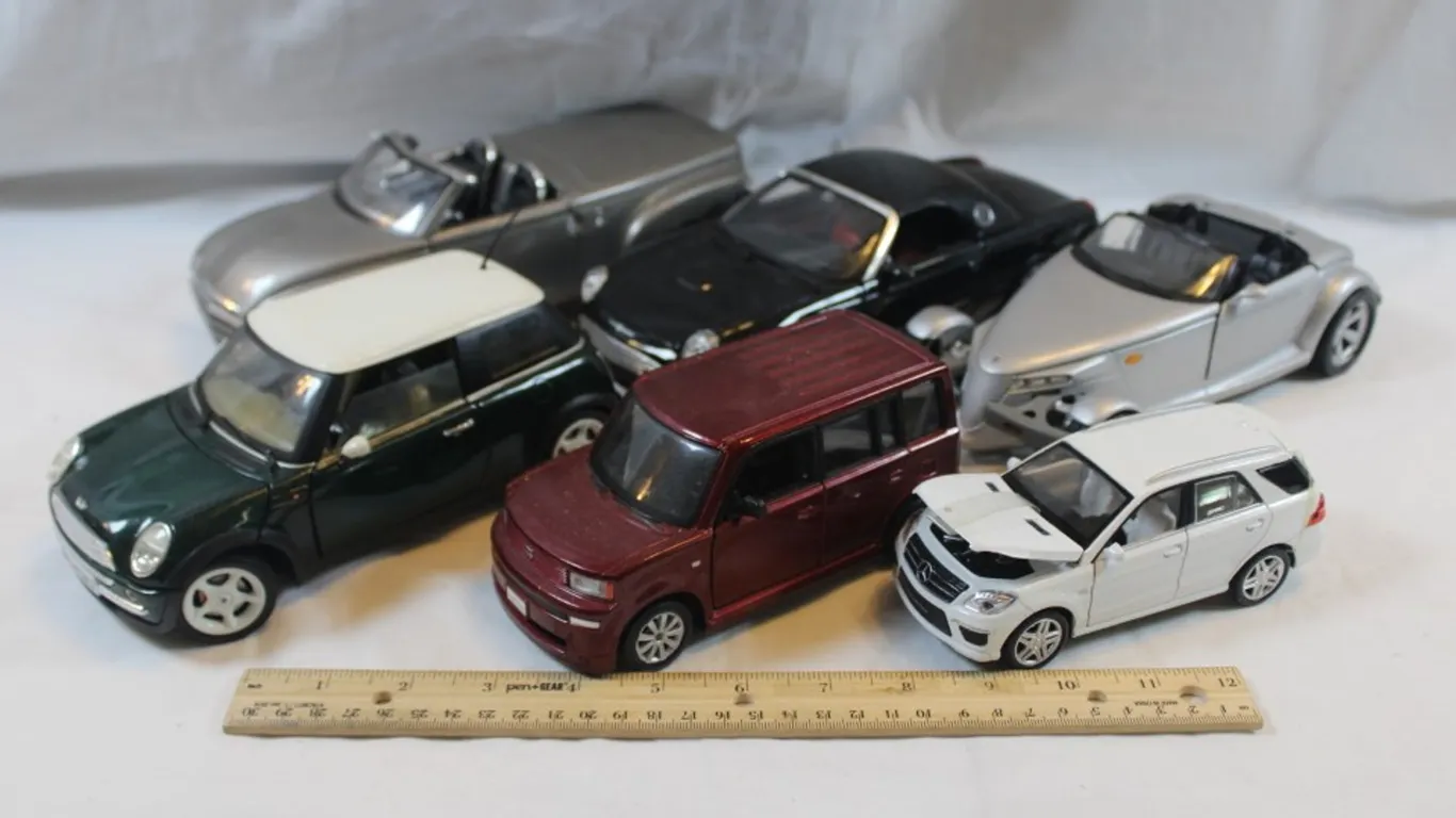 Six Diecast Cars, Plymouth Prowler Maisto, 1:18 Scale Thunderbird, 1:18 Scale Mini Cooper, 1:18 Scale 2000 Chevy SSR, 1:24 Scale Scion xB, and 1:32 Sc