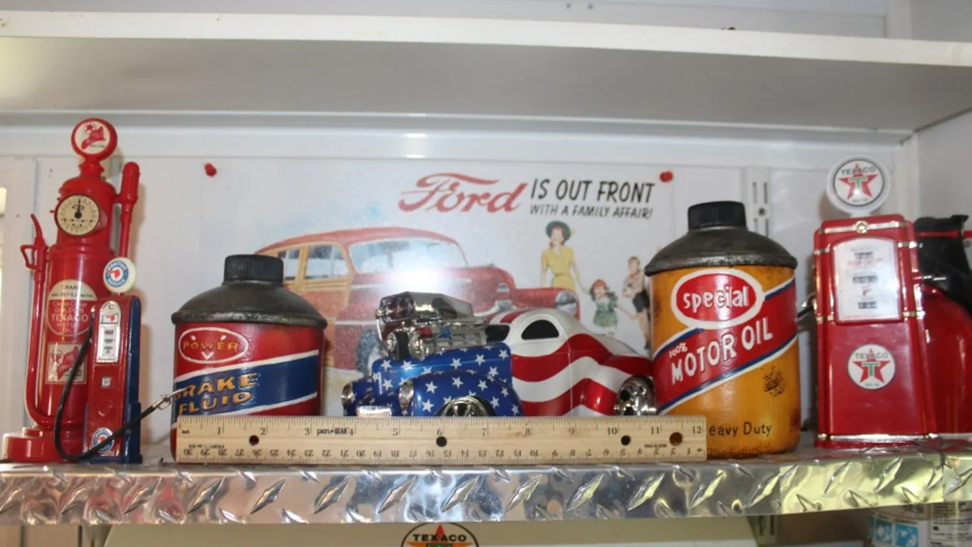 Model Gas Pumps, Oil Can Stash Containers, a Master Mechanic's Willys Coupe Hot Rod, and a Tin Ford Sign