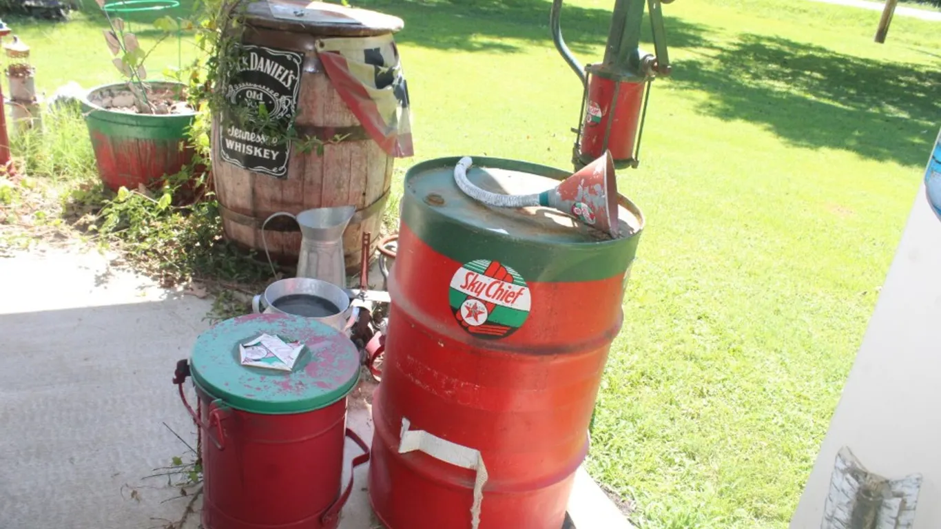 Fuel Barrel with Pump (Locked up), Funnel, and Trashcan