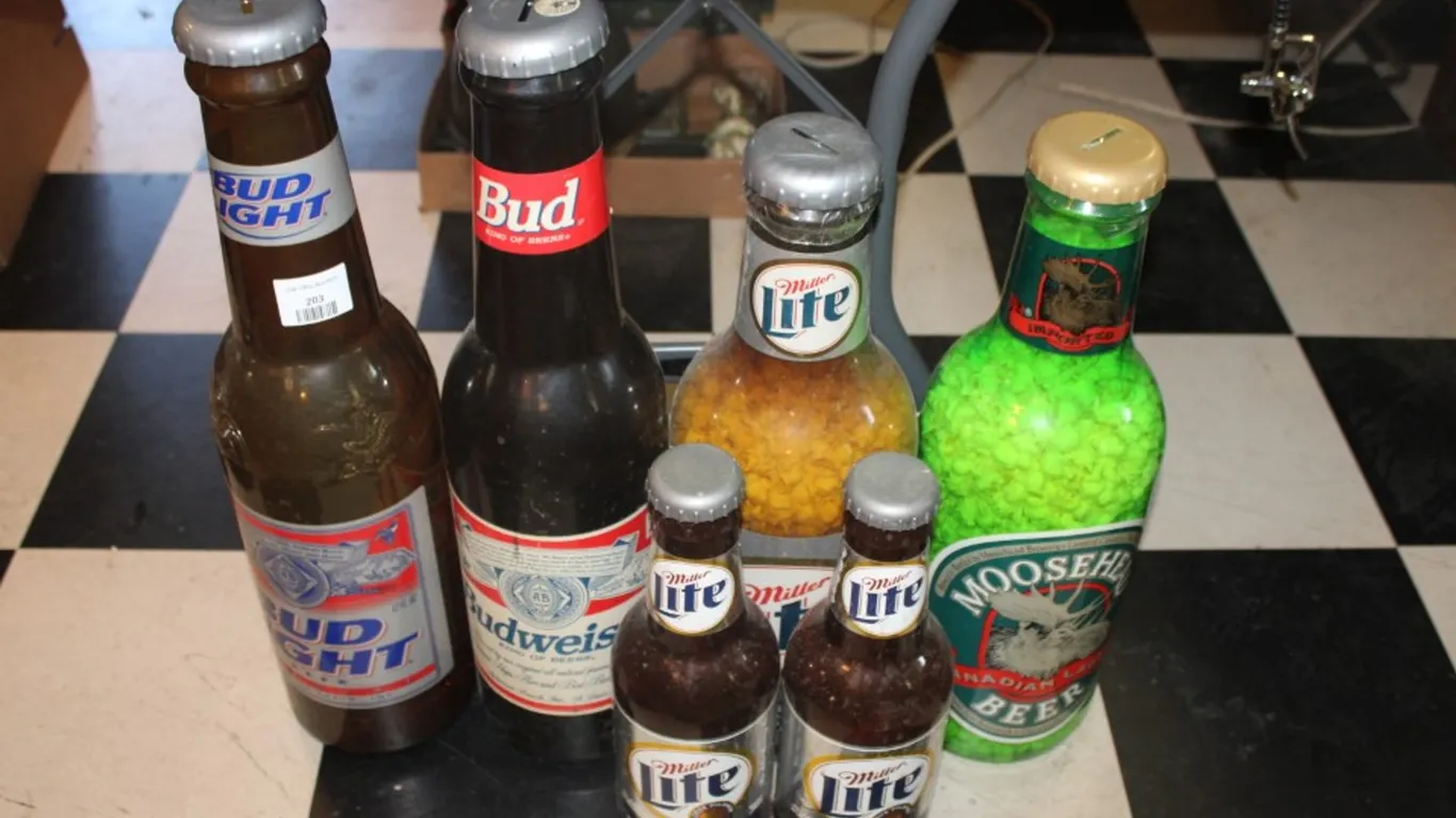 Beer Bottle Coin Banks Ranging from 20 Inches Tall Down to 14 Inches Tall