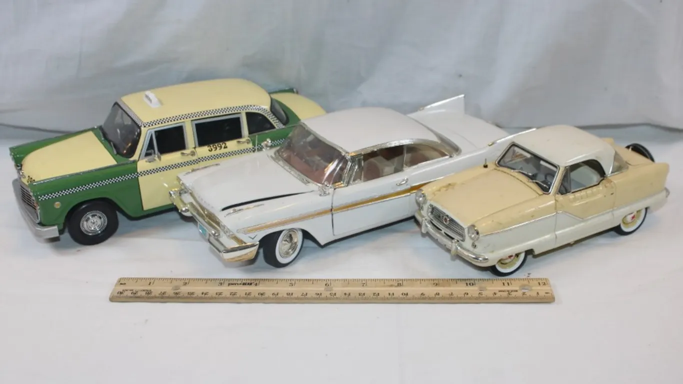 Three Cars, Two 1:18 Scale and One 1:24 Scale, 1957 Plymouth Fury, 1959 AMC Metropolitan, 1961 Checker A11