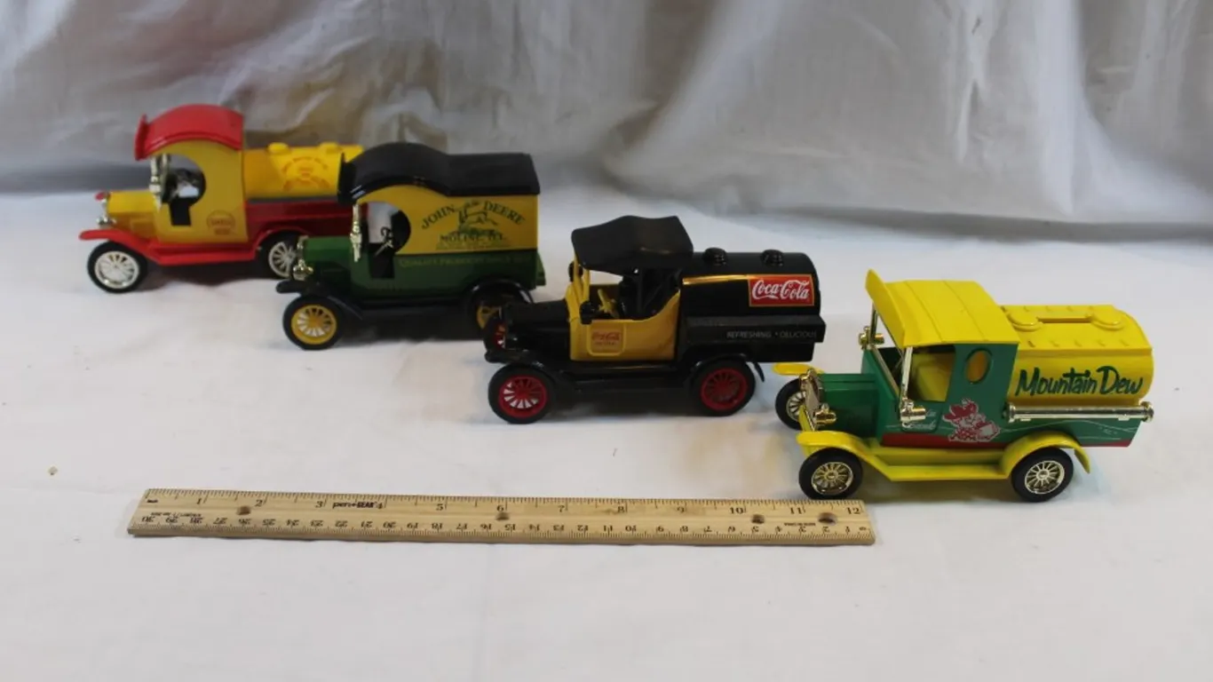 Four Advertising Diecast Trucks: John Deere, Coca-Cola, Mountain Dew, and Shell