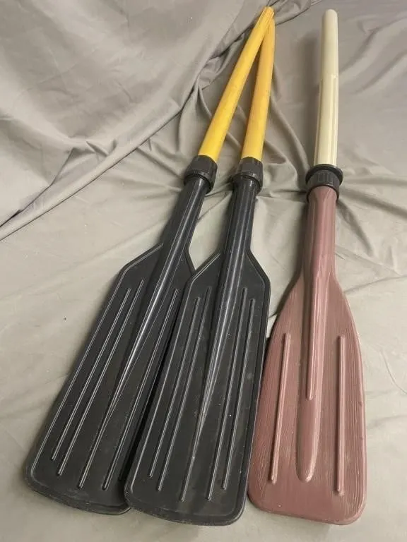 Three detachable plastic boat oars.