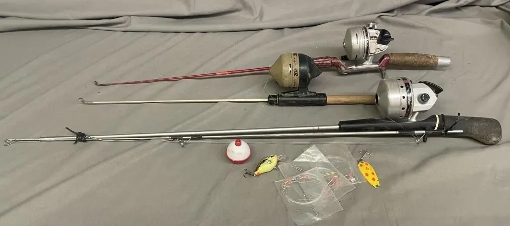Three ice fishing rods and reels with some lures.