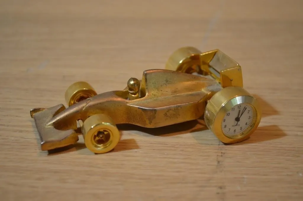 Brass-tone Formula 1 race car desk clock