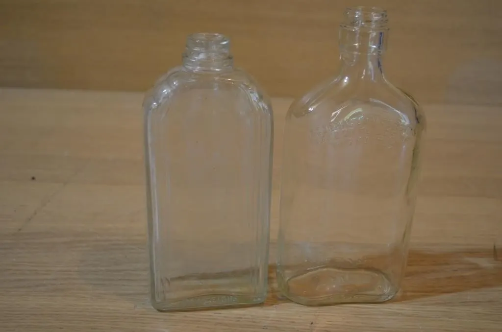 Vintage clear glass bottles featuring the embossed