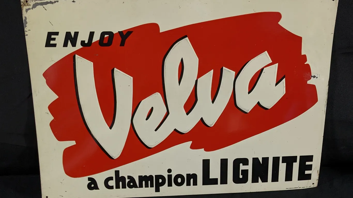 EMBOSED TIN SIGN ENJOY VELVA A CHAMPION LIGNITE COAL NORTH DAKOTA