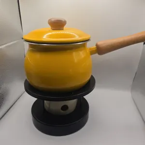 Vintage yellow fondu pot on stand