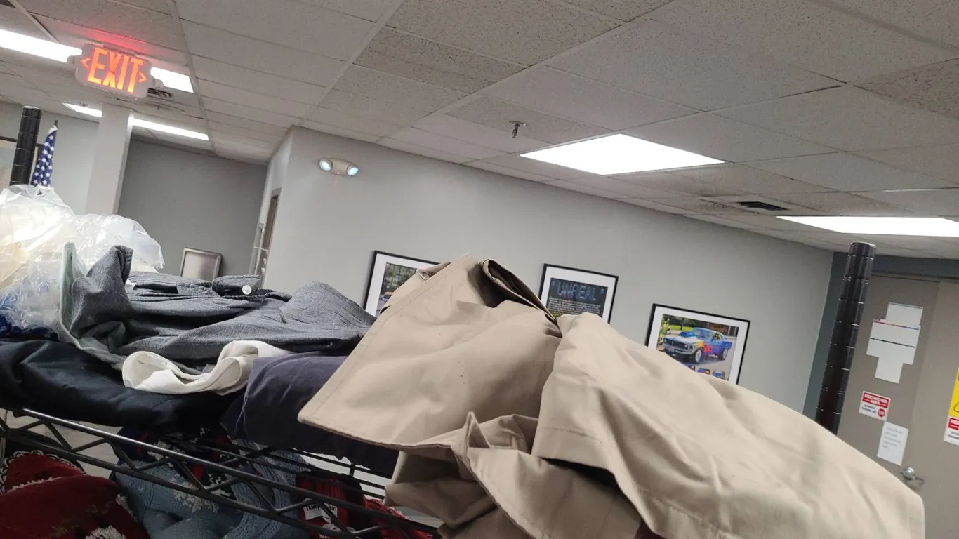 Clothing Lot from Top Shelf of the 3rd Cart Including Shirts, Jackets, and Coats in Multiple Colors