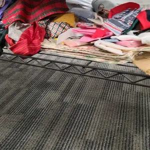Bottom Shelf of the 3rd Cart with Assorted Fabric Remnants, Pattern Pieces, and Sewing Notions Colle