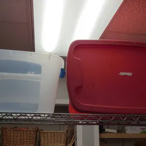 Storage Totes Including Bella Plastic Bin and Red Sterilite Container from Top Shelf of 2nd Cart