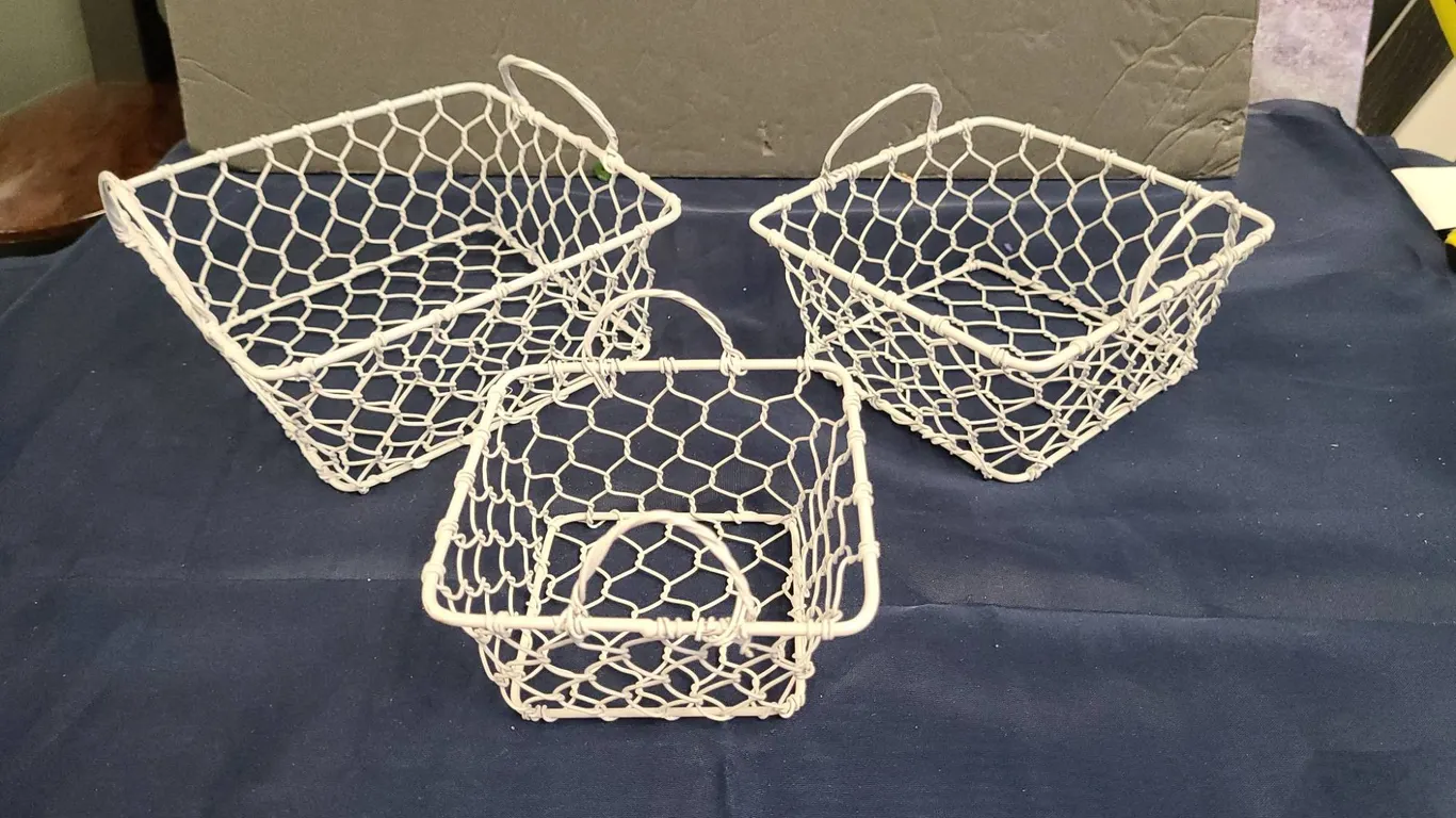 Three White Wire Baskets with Hexagonal Mesh Pattern and Attached Handles on Each Basket, Square Sha