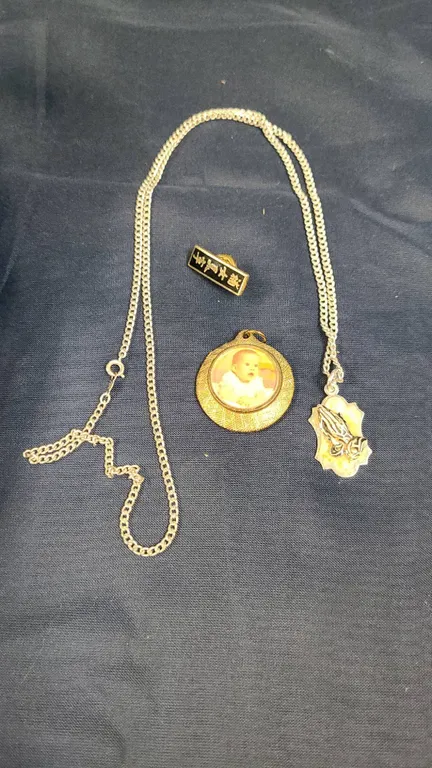 Jewelry Lot with Gold-Tone Baby Photo Locket, Woerner Praying Hands Pendant, and Pin with Asian Scri