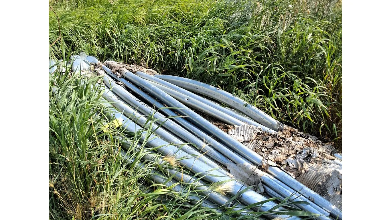 Frame Pipes Tarped Building