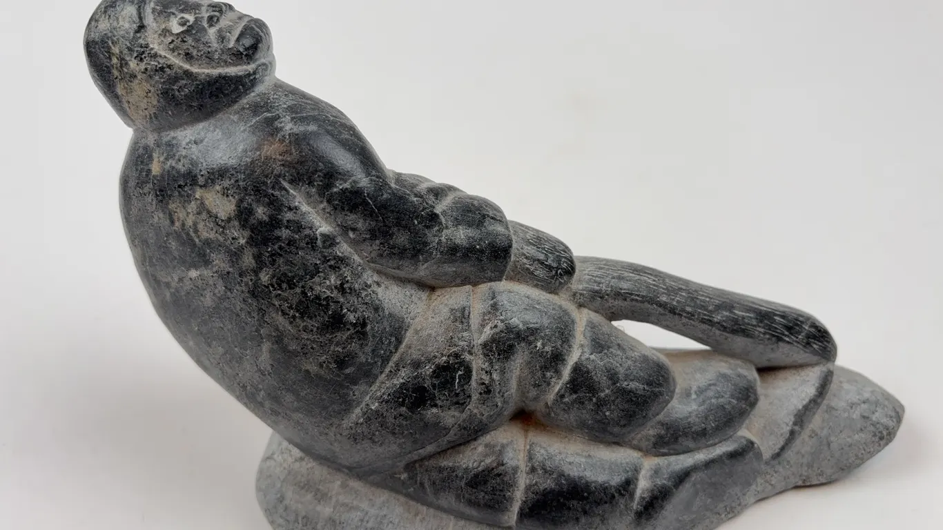 Inuit Soapstone Hunter on Sled Sculpture