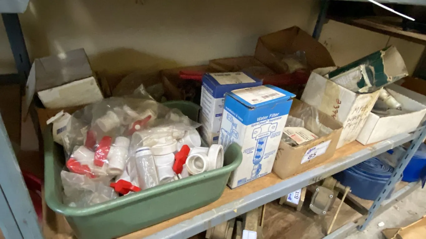 SHELF OF ASSORTED WATER FILTERS, PUMP PARTS & HARDWARE