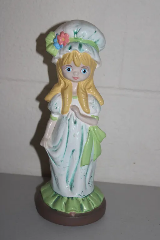 Hand-Painted Ceramic Figurine Signed PAM F Depicting Blond Girl in Bonnet with Flowers and Green Acc