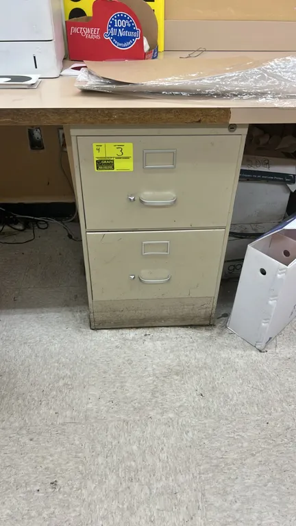2-drawer metal filing cabinets. Features beige finish, integrated label holders, and metal pull handles. Desk and surrounding contents not included.
