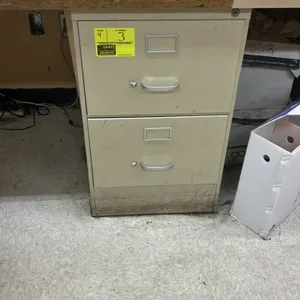 2-drawer metal filing cabinets. Features beige finish, integrated label holders, and metal pull handles. Desk and surrounding contents not included.