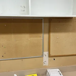 Laminate built-in counters and wooden overhead shelving units. Features laminate work surfaces with integrated backsplashes and multi-compartment wall