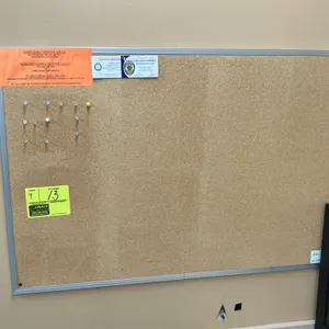 Cork bulletin boards. Features assorted aluminum and wood frames with natural cork surfaces. 3' x 2' each. Wall mountable. Contents and surrounding fi