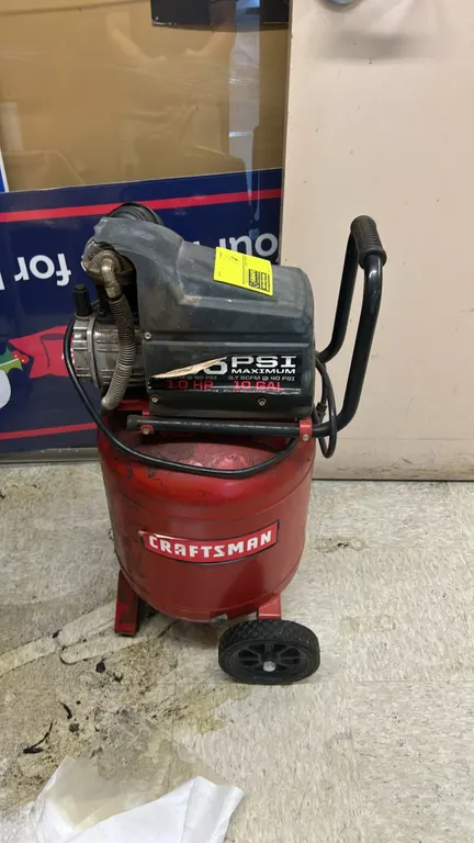 Craftsman 10-gallon portable vertical air compressor. Features 1.0 HP motor, 3.7 SCFM at 40 PSI rating, pressure gauge, integrated transport handle, a