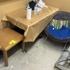 Furniture lot. Includes folding saucer chair with fabric upholstery and metal frame, 4' poly collapsible folding table, and wooden side table. Content