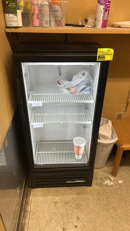 True GDM-10SSL-HC~TSL01 single-door glass merchandiser cooler. Features self-contained refrigeration, LED interior lighting, hinged glass door, black
