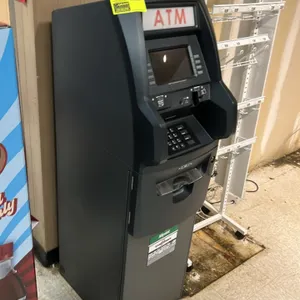 Triton Traverse retail ATM machine. Features illuminated ATM topper, color display screen, numeric PIN pad, card reader, receipt printer, and cash dis
