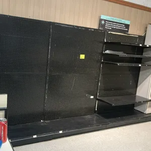 15'L of Lozier wall shelving. Features 78"H uprights with 19"D base shelves, black pegboard backing, and metal upper shelves. Note: Sold by the foot.