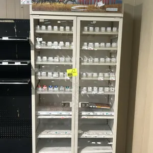 Metal 2-door locking multi-tier tobacco merchandiser. Features Marlboro graphic header panel, double glass doors with locking handles, and multi-tier 