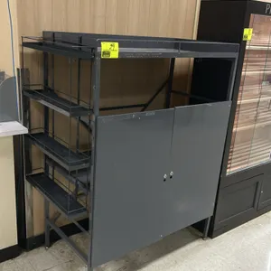 Metal multi-tier display rack cabinet. Features a 2-door lower storage compartment, top storage tier, and side-mounted 4-tier wire basket shelving. Gr