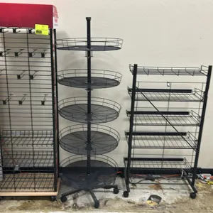 Metal mobile multi-tier display merchandisers. Includes (1) grid tower rack with hanging hooks, lower wire baskets, and header; (1) 5-tier round rotat