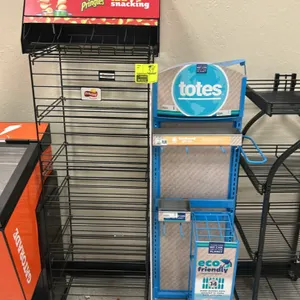 Assorted metal multi-tier retail merchandiser display racks. Includes various floor-standing and spinning display fixtures such as rolling wire displa