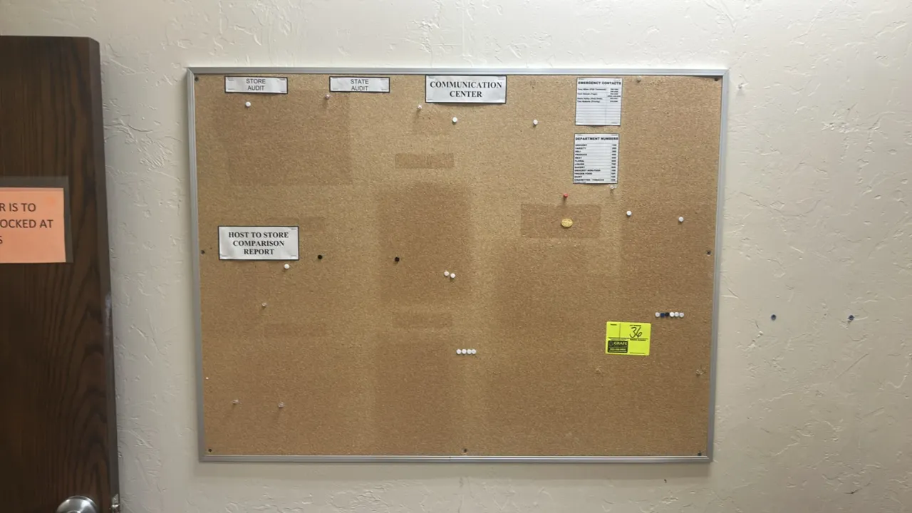 Cork bulletin board. Features an aluminum frame and natural cork surface. Dimensions: 4' x 3'.