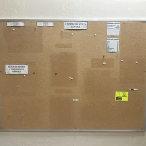 Cork bulletin board. Features an aluminum frame and natural cork surface. Dimensions: 4' x 3'.