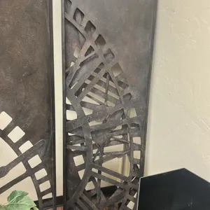 Metal 3-panel folding room dividers. Features cut-out Roman numeral clock face design, rustic bronze-tone finish, and hinged panel construction. Decor