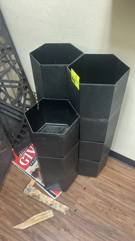 Hexagonal poly stackable pots. Features black molded plastic construction and stackable hexagonal design.