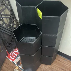 Hexagonal poly stackable pots. Features black molded plastic construction and stackable hexagonal design.