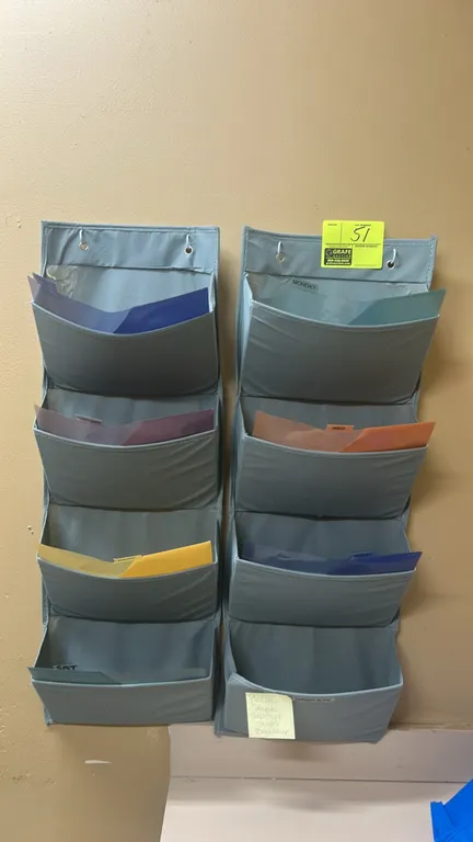 Multi-tier fabric wall-hanging organizers. Includes (2) 4-pocket hanging organizers with metal grommets. Contents not included.